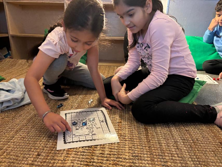 Two students playing a math game.