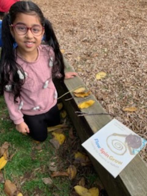 Student outside making patterns with nature.