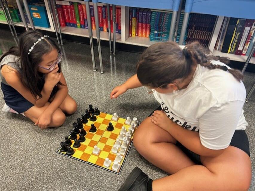 Two students playing chess.