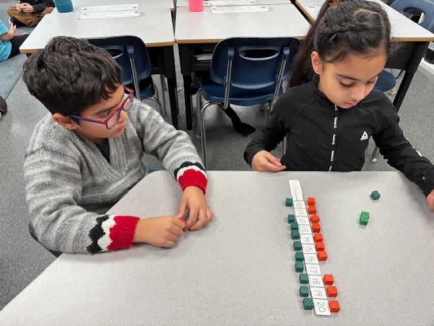 Two students playing a math game.