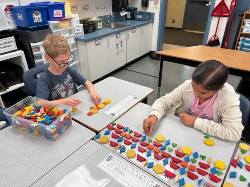 Students making patterns with coloured tiles