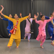 a Group of elementary students perform a dance for Ramadan celebrations