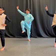 3 elementary boys perform a dance for Ramadan celebrations