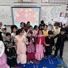 Elementary students gathered in the classroom dressed in traditional attire to celebrate Diwali